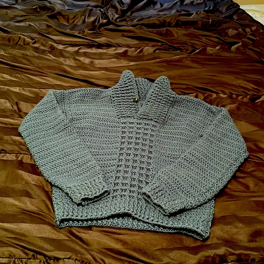 Crochet turquoise sweater.